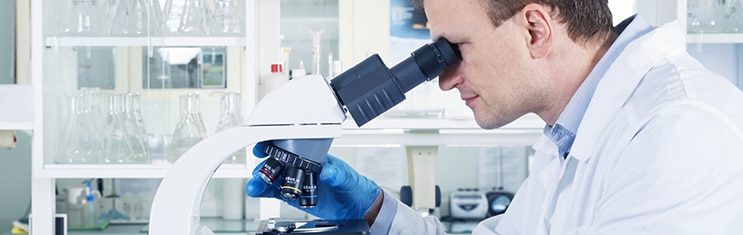 Portrait of caucasian male chemist scientific researcher using microscope in the laboratory interior; Shutterstock ID 349971419; PO: redownload; Job: redownload; Client: redownload; Other: redownload